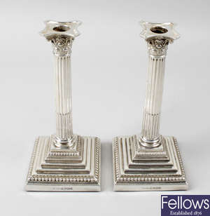 A pair of modern silver mounted Corinthian column candlesticks.