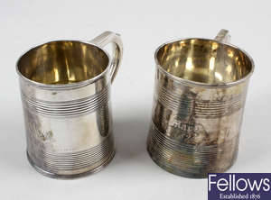 A George III small silver mug of tapered form & a similar George IV example. (2).