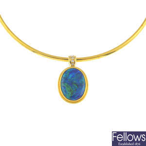 A black opal and diamond pendant, on 18ct gold collar.
