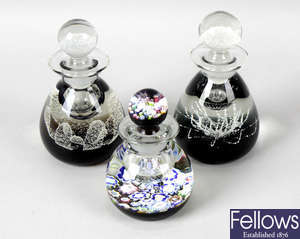 A group of assorted paperweights, to include Caithness examples, together with a Waterford cut glass lustre candle holder, and two similar candlesticks.