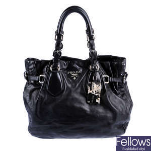 PRADA - a black leather handbag.