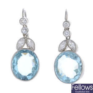 A pair of diamond and aquamarine earrings.