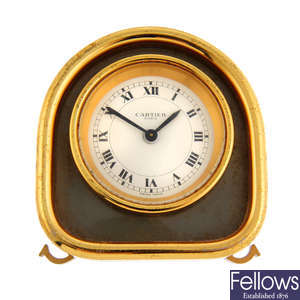A gold plated alarm clock by Cartier.