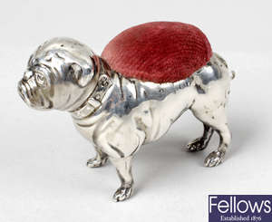 A silver pin cushion modelled as a pug dog.