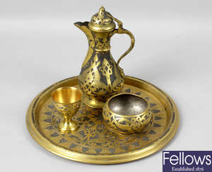 An early 20th century gilt metal tray, a similar coffee pot with hinged cover, etc.