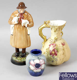 A small Moorcroft pottery vase, together with a Royal Worcester bone china jug, and a Royal Doulton figurine.