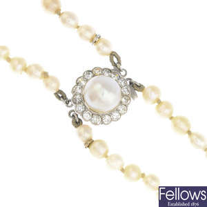 An early 20th century natural pearl two-row necklace, with pearl and diamond clasp.