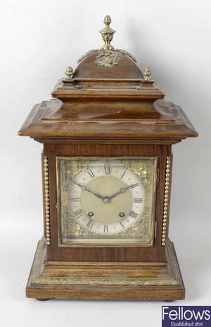 An early 20th century stained wooden cased bracket style mantel clock.