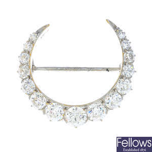 TIFFANY & CO. - a diamond crescent brooch.