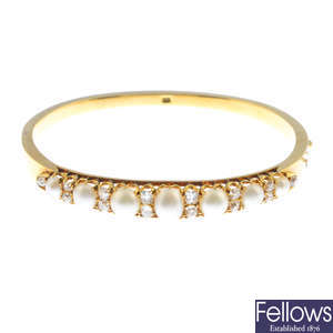 A late Victorian 18ct gold split pearl and diamond hinged bangle.