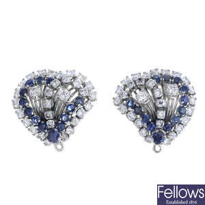 A pair of diamond and sapphire heart earrings.