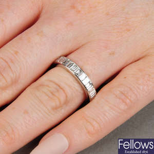 A platinum baguette-cut diamond full eternity ring.