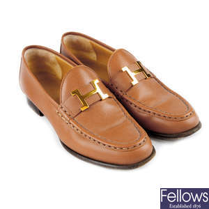 HERMÈS - a pair of tan leather 'H' loafers.
