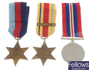 WWII medals, group of four & group of three, with postage boxes.