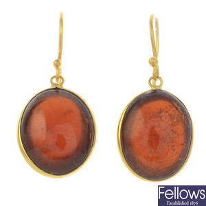 A pair of garnet single-stone earrings.