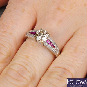 A brilliant-cut diamond single-stone ring, with calibre-cut ruby and pave-set diamond shoulders.