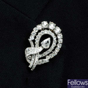 A mid 20th century platinum and 18ct gold, old-cut diamond scroll brooch, monture Cartier.