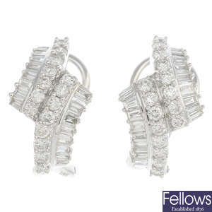 A pair of 18ct gold diamond scroll earrings.