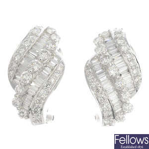 A pair of 18ct gold diamond scroll earrings.