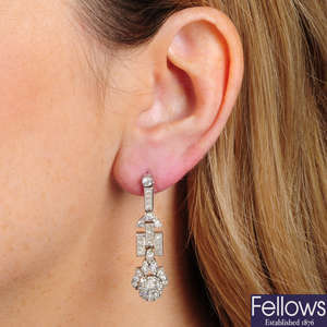 A pair of vari-cut diamond geometric drop earrings.