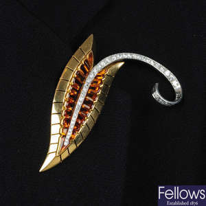 A 1940s platinum and 18ct gold citrine and diamond foliate brooch.