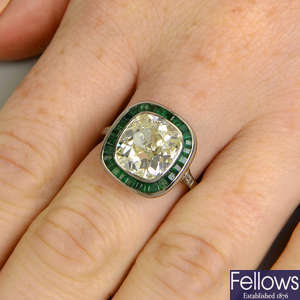 A cushion-shape old-cut diamond and calibre-cut emerald ring.