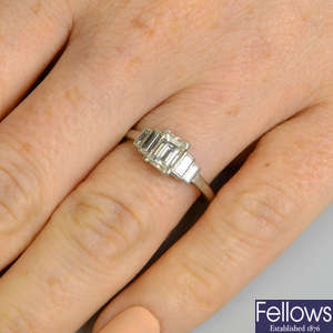 A rectangular-shape diamond single-stone ring, with baguette-cut diamond stepped shoulders.