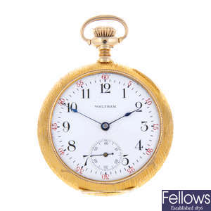 A yellow metal open face fob watch by Waltham.