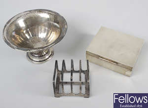 A group of assorted silver items, to include a toast rack, a silver mounted cigarette box, a Danish footed dish, etc.