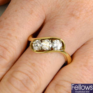 An 18ct gold brilliant-cut diamond three-stone ring.