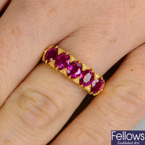 A ruby five-stone ring, with diamond accents.