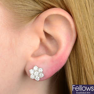 A pair of brilliant-cut diamond cluster earrings.