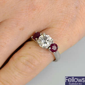 A brilliant-cut diamond and ruby three-stone ring.