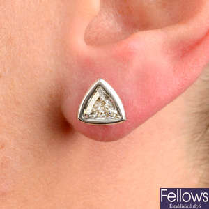 A pair of triangular-shape diamond collet stud earrings.