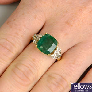 An emerald single-stone ring, with vari-cut diamond shoulders.