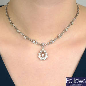 A diamond cluster pendant, with integral diamond-set fancy-link chain.