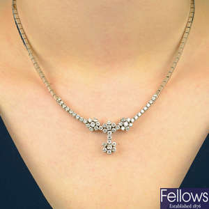 A brilliant-cut diamond floral cluster necklace.