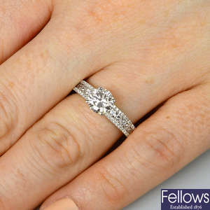 A platinum brilliant-cut diamond single-stone ring, with similarly-cut diamond line sides.