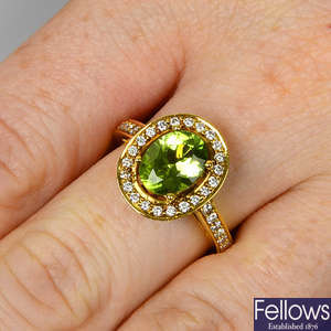 A peridot and brilliant-cut diamond cluster ring.