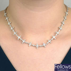 A graduated diamond cluster necklace.