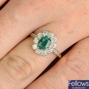 An emerald and diamond floral cluster ring.