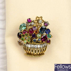 A diamond and gem-set floral brooch.