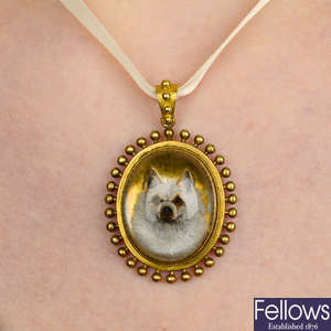 A late Victorian gold reverse-carved and painted rock crystal intaglio pendant, depicting a Pomeranian dog.