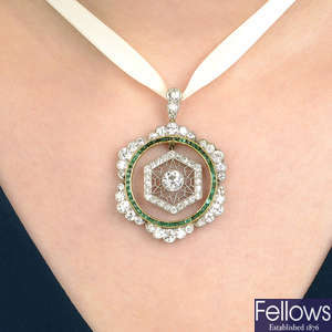 A composite early 20th century platinum and gold, emerald and diamond pendant.