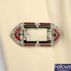 An Art Deco platinum and gold, onyx, enamel and diamond brooch.