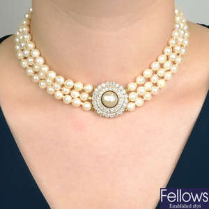 A mid 20th century cultured pearl three-row necklace, with pearl and old-cut diamond cluster clasp.