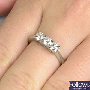A platinum brilliant-cut diamond three-stone ring.