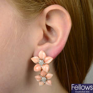 A pair of carved coral and brilliant-cut diamond floral earrings.