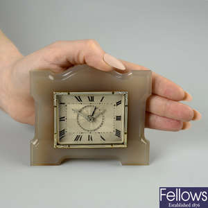 An Art Deco agate French desk clock, with diamond hands, attributed to Boucheron.