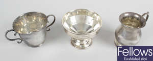 A 1920's Irish silver twin-handled cup, plus a christening mug, a footed bowl & a pedestal cup. (4). 